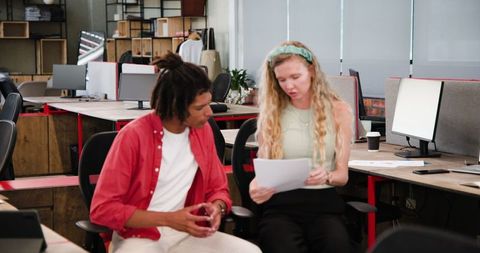 Colleagues Collaborating on Documents in Modern Office