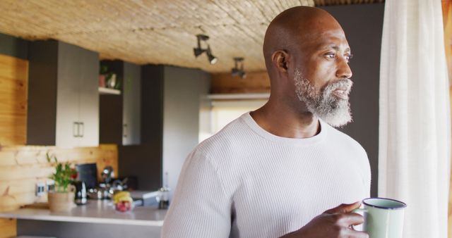 Pensive Middle-aged Man Drinking Coffee in Modern Kitchen - Download Free Stock Images Pikwizard.com