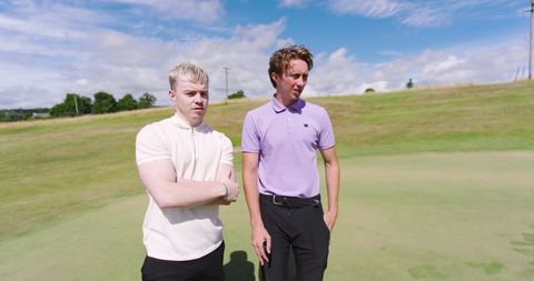 Male Golf Partners Observing Scenic Golf Course View