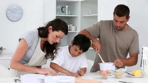 Family Enjoying Baking Together in Bright Kitchen