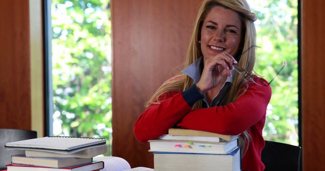 Confident Student Studying with Textbooks in Classroom - Download Free Stock Images Pikwizard.com