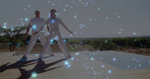 Couple Practicing Mindful Movement on Poolside Deck with Blue Light Particle Overlay
