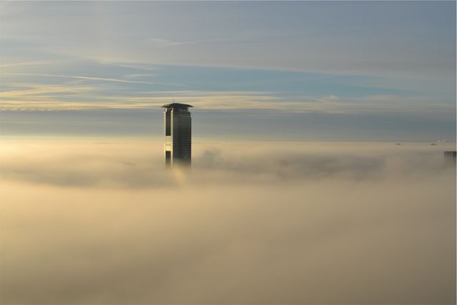 High-Rise Building Emerging Through Fog at Sunrise - Download Free Stock Photos Pikwizard.com
