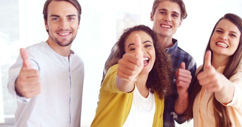 Cheerful Young Adults Giving Thumbs Up for Success - Download Free Stock Images Pikwizard.com