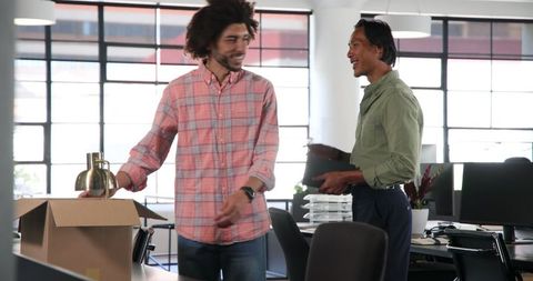 Colleagues unpacking office box cooperation