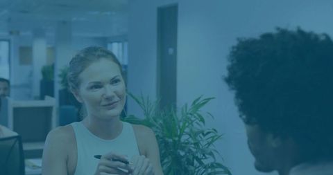 Professional Woman Leading Office Discussion in Modern Workspace