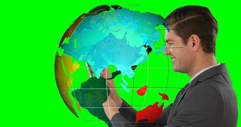 Businessman interacting with digital globe on green background