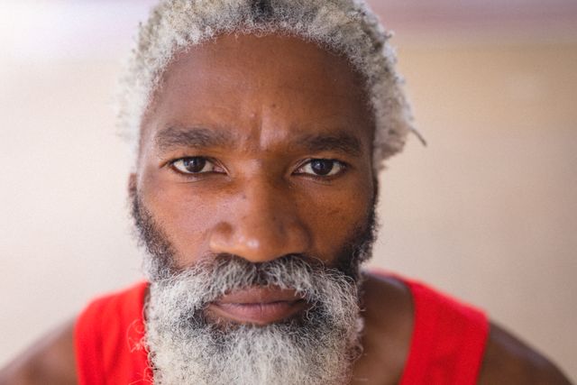 Portrait of white bearded senior african american man with serious expression at home. unaltered, people and emotions concept.