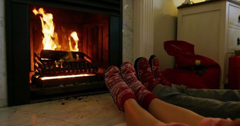 Couple Relaxing by Warm Fireplace in Cozy Home Setting