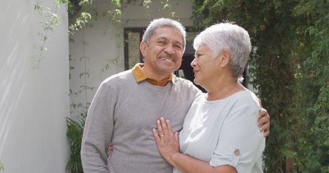 Senior Couple Embracing Peacefully in Sunny Garden - Download Free Stock Images Pikwizard.com