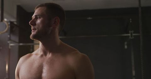 Athletic Caucasian Man Stretching in Gym