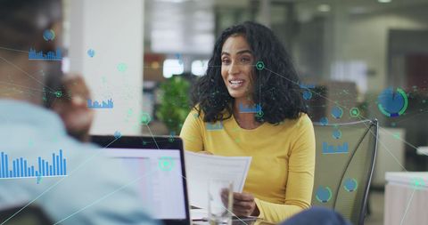 Businesswoman Analyzing Data with Digital Infographics Overlay