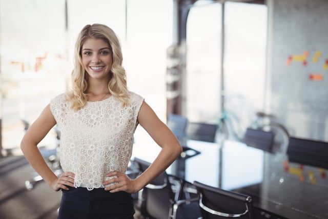 Portrait of confident businesswoman standing in meeting room at office