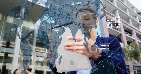 Businesswoman holding tablet displaying holographic world map, data overlays in urban plaza
