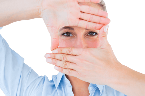 Woman appearing focused while making a frame with her hands, letting a concept of transparency and vision come through. Useful for themes of focus, creativity, and perspective.