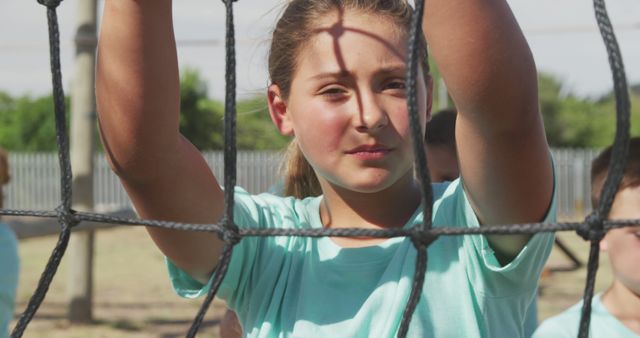 Middle School Girl Holding Sports Net Outdoors on Sunny Day - Download Free Stock Images Pikwizard.com