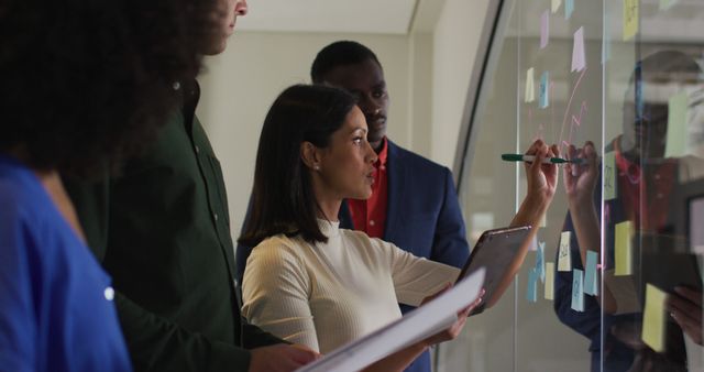 Team brainstorming ideas on transparent board in modern office - Download Free Stock Images Pikwizard.com