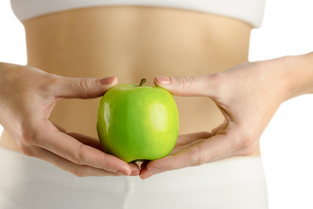 Slim Woman Holding Green Apple Focused on Transparent Healthy Lifestyle - Download Free Stock Videos Pikwizard.com