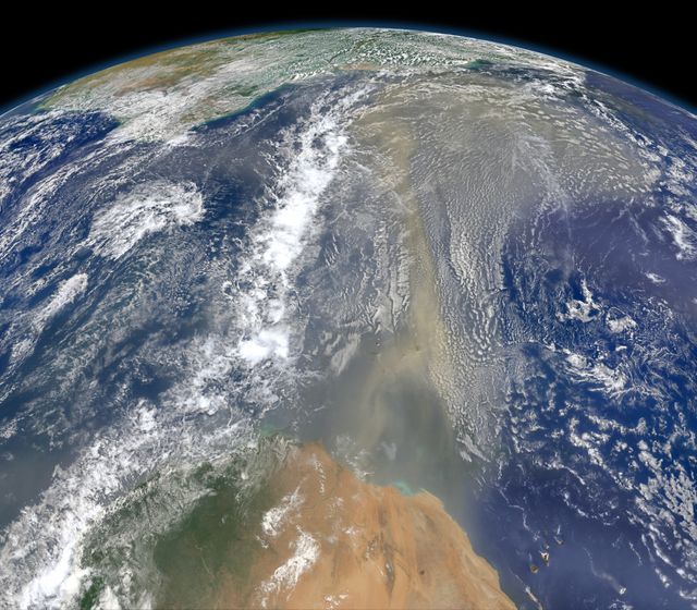 Composite satellite image showing Saharan dust heading westward towards South America and Gulf of Mexico on June 25, 2014. This annual dust transfer helps replenish nutrients in the Amazon Basin but can negatively impact air quality and coastal ecosystems. Suitable for educational materials, environmental studies, climate change discussions, and geography content.