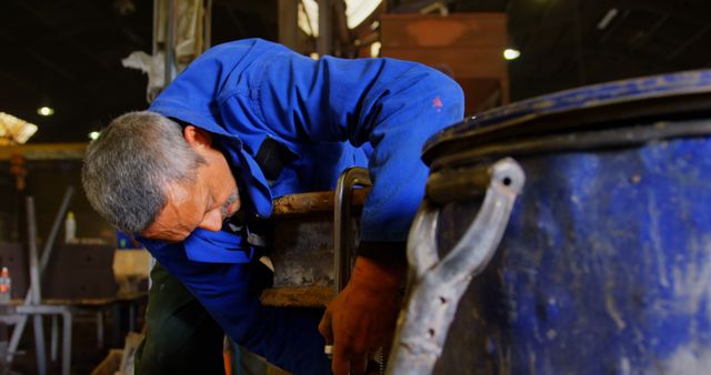 Metalworker Repairing Industrial Equipment in Workshop - Download Free Stock Images Pikwizard.com