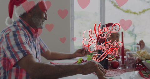Grandfather Celebrating Christmas with Grandchildren at Festive Table