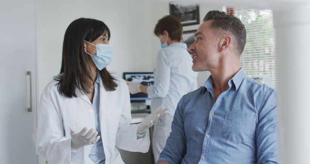 Dentist Conversing with Patient in Modern Clinic - Download Free Stock Images Pikwizard.com