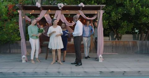 Interracial Seniors Exchanging Vows in Intimate Backyard Wedding