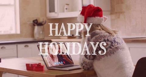 Woman in santa hat on laptop video call celebrates holidays