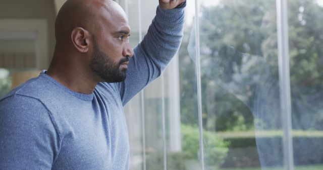 Profile of biracial man looking out window at home - Download Free Stock Photos Pikwizard.com