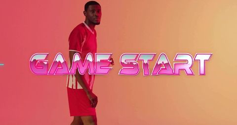 Game start neon over male athlete wearing red jersey and shorts on gradient pink backdrop