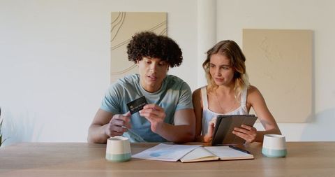 Young couple discussing financial plans together at table