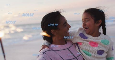 Joyful Mother and Daughter Bonding at Beach Sunset