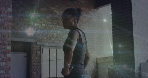 Fit Woman Halting in Urban Space Illuminated by Digital Energy