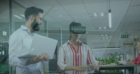 Coworkers Collaborate with VR Technology in Modern Office Environment