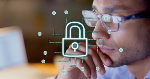 Hispanic professional analyzing cybersecurity risks with glowing padlock overlay
