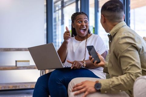 Excited team brainstorming in modern office setting