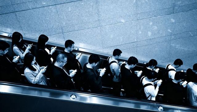 Commuters scrolling smartphones on escalator in urban transit minimalist overhead composition