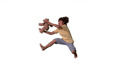 Joyful Boy Jumping to Catch Plush Teddy Bear