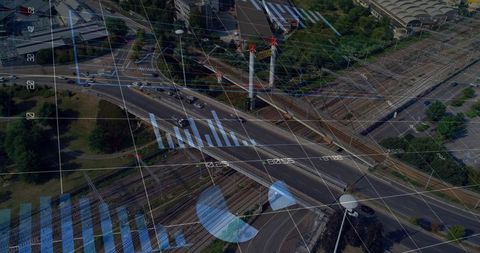Urban highway interchange with data analytics overlay showing traffic flow, rail lines