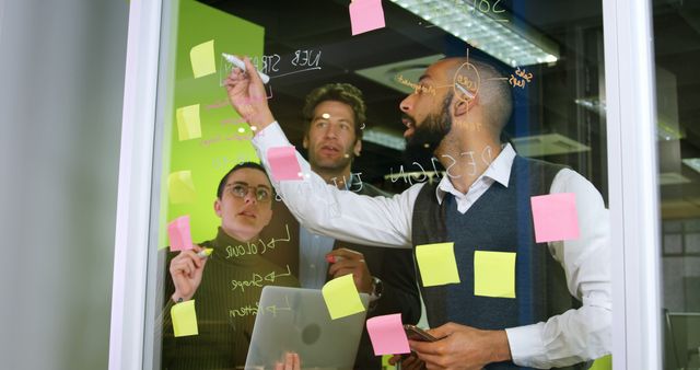 Mixed Team Collaborating with Sticky Notes on Glass Wall - Download Free Stock Images Pikwizard.com