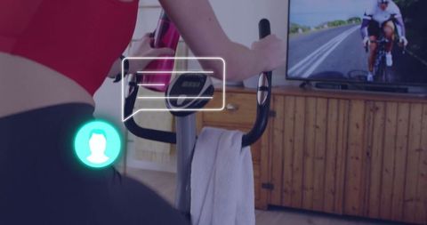 Woman Exercising on Stationary Bike with TV Motivation at Home Gym