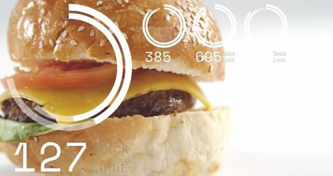 Melting cheddar burger closeup with sesame bun, tomato and minimalist ui overlay