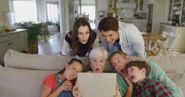 Silly Family Watching Tablet Together in Living Room - Download Free Stock Images Pikwizard.com