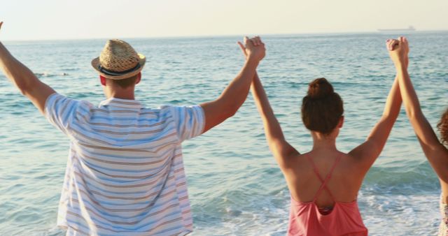 Joyful friends holding hands at beach - Download Free Stock Images Pikwizard.com