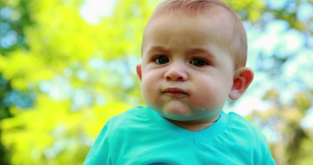 Baby Making a Face Outdoors on a Sunny Day - Download Free Stock Images Pikwizard.com