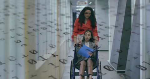 Businesswomen Collaborating in Modern Office Hallway