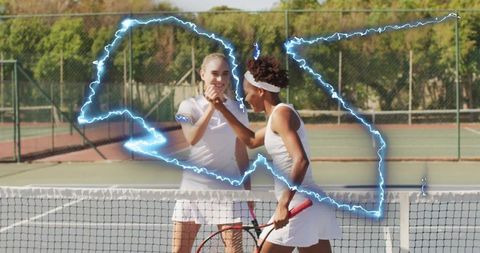 Two women tennis players displaying sportsmanship on court