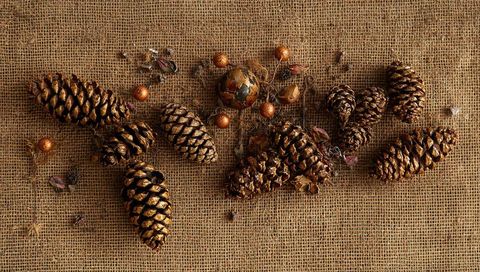 Gold Painted Pine Cones and Metallic Ornaments on Burlap Rustic Holiday Tabletop