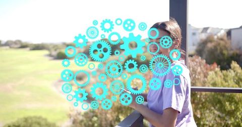 Young woman leaning on balcony overlooking park with turquoise mechanical gears overlay