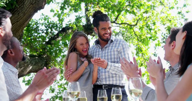 Engaged Couple Celebrating Together Outdoors with Friends - Download Free Stock Images Pikwizard.com